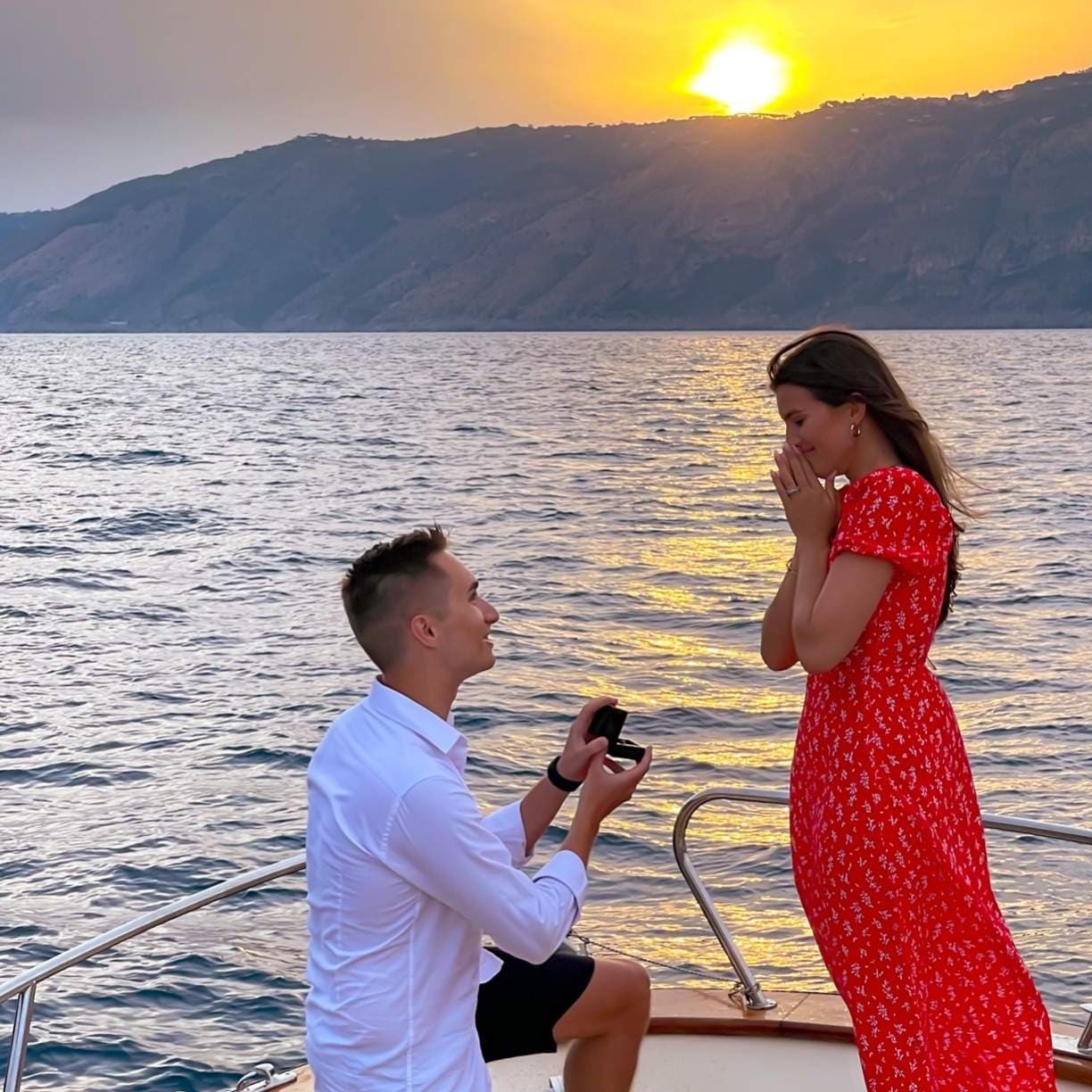 Couple boat proposal at sunset over Mediterranean sea, romantic