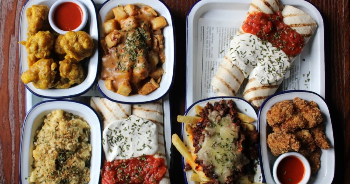Assorted plated comfort foods overhead shot in restaurant spread