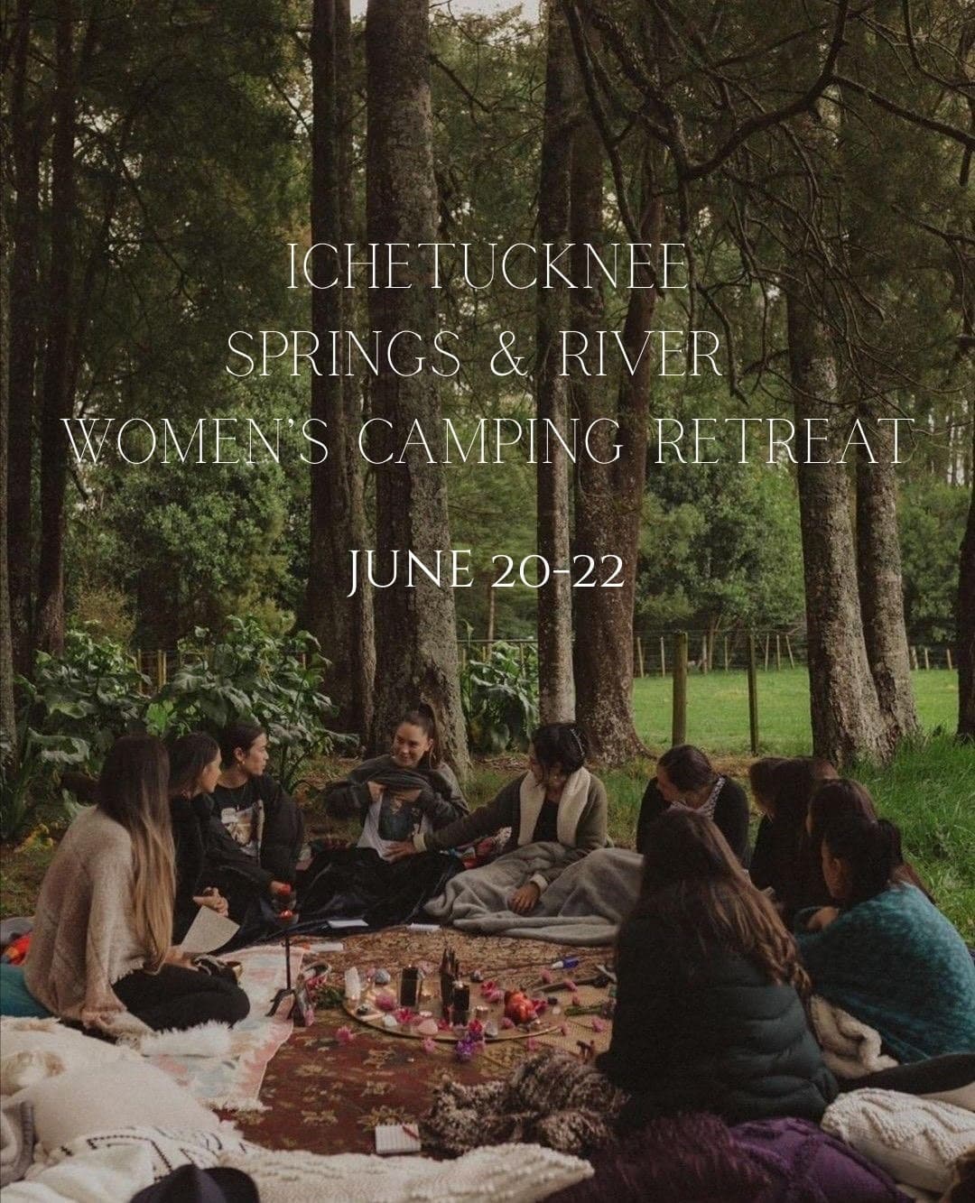 Women gathered in forest campsite circle for outdoor retreat