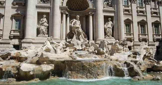 Visitors admiring Trevi Fountain, Rome historic fountain scene