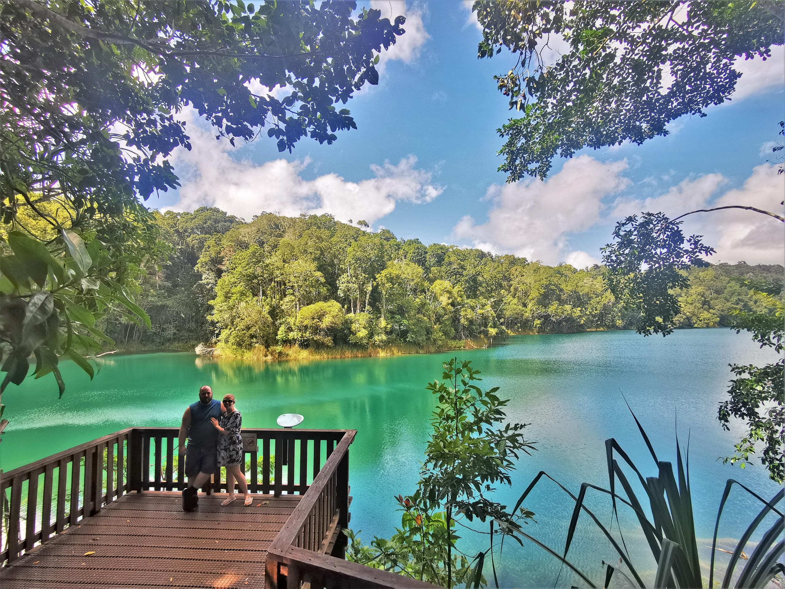 Scenic turquoise crater lake viewed from wooden boardwalk overlook