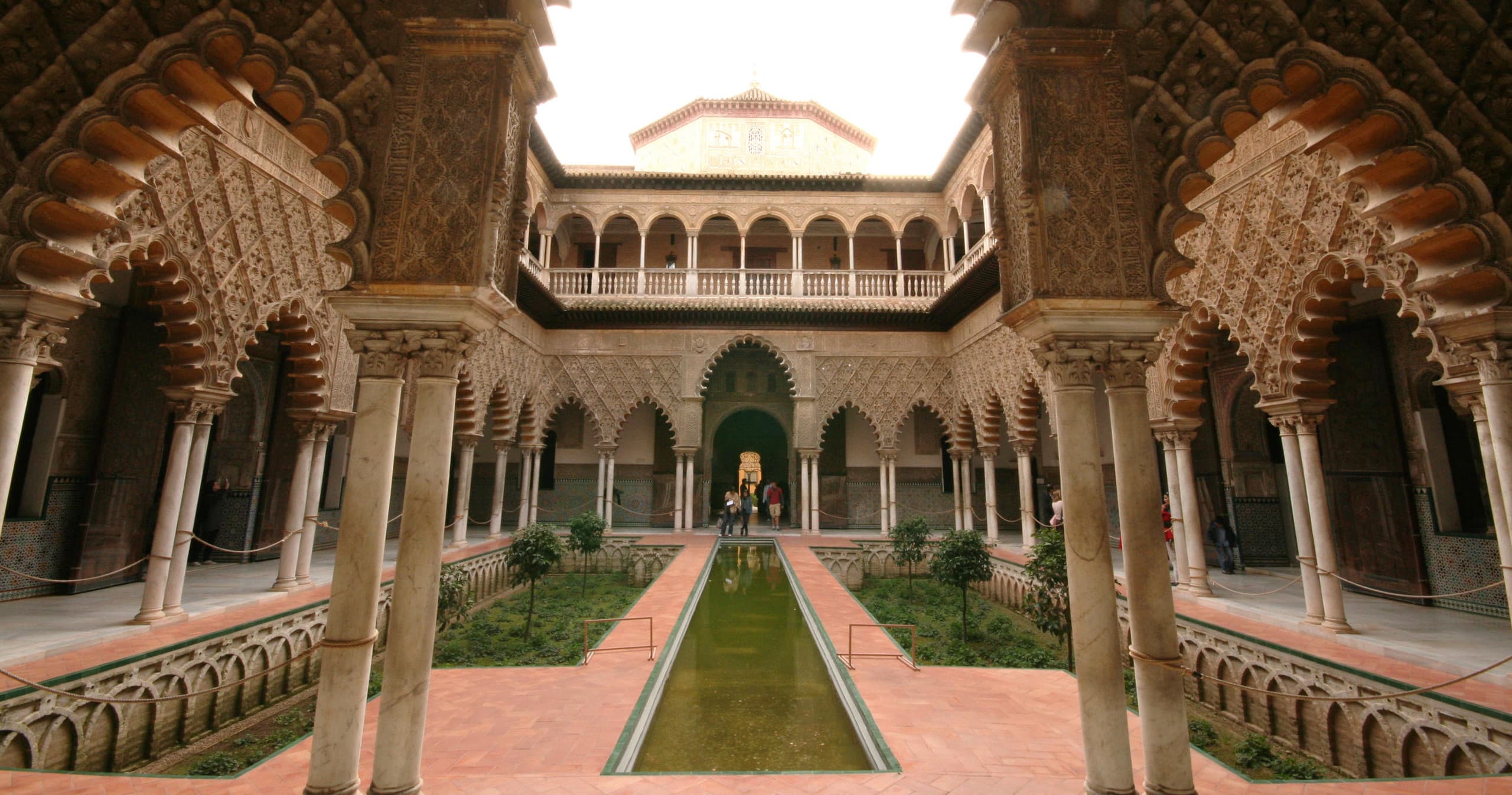 Real Alcázar courtyard garden with Moorish arches in Seville