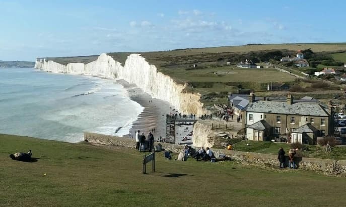 E-bike riders overlooking chalk cliffs and coastal vista
