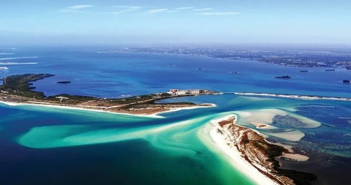 Aerial view of tropical sandbars and turquoise coast, island exploration