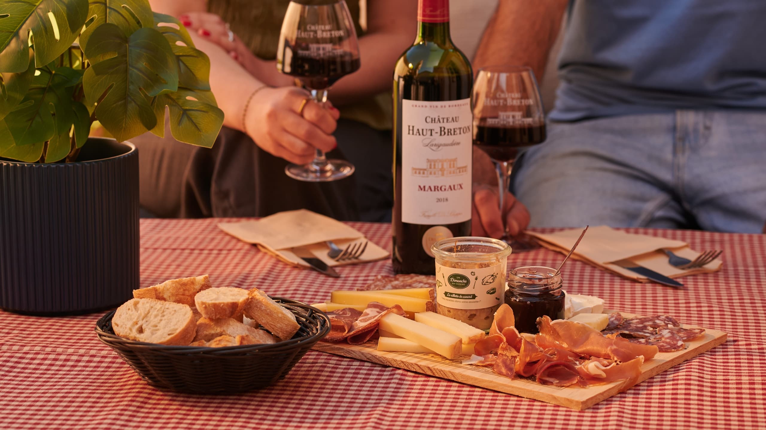 Outdoor-style charcuterie spread with wine bottle on picnic table