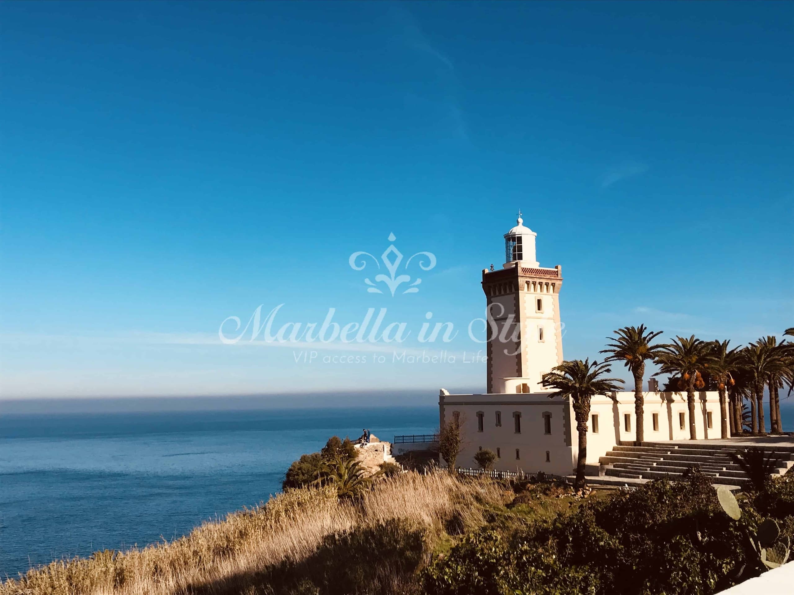 Coastal lighthouse overlooking Mediterranean cliffs near Marbella