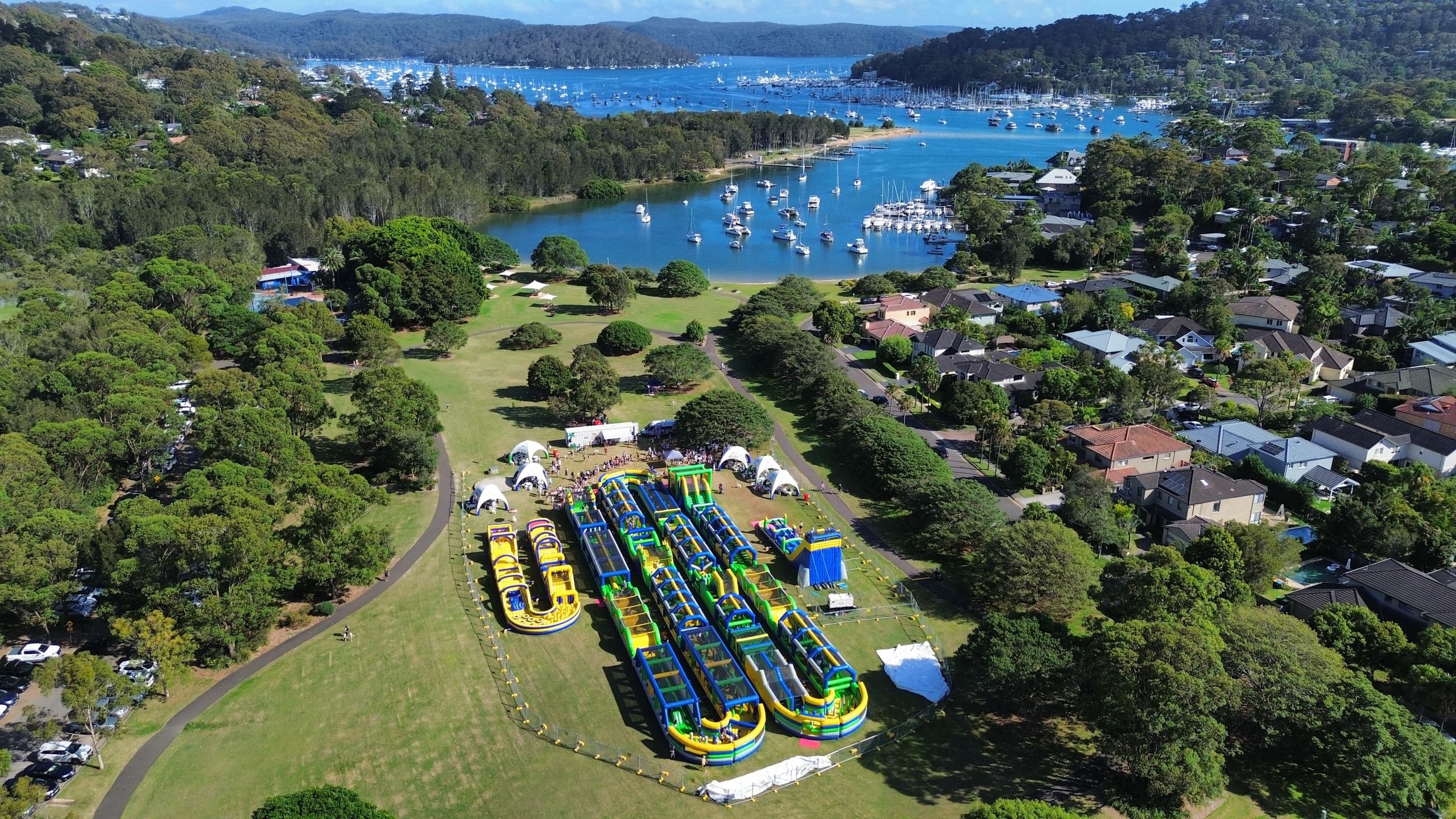 Inflatable obstacle course set on waterfront park overlooking bay