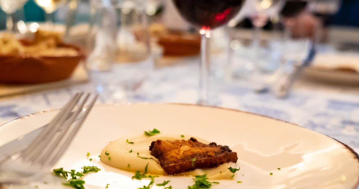 Close-up of plated appetizer with herbs in fine dining setting