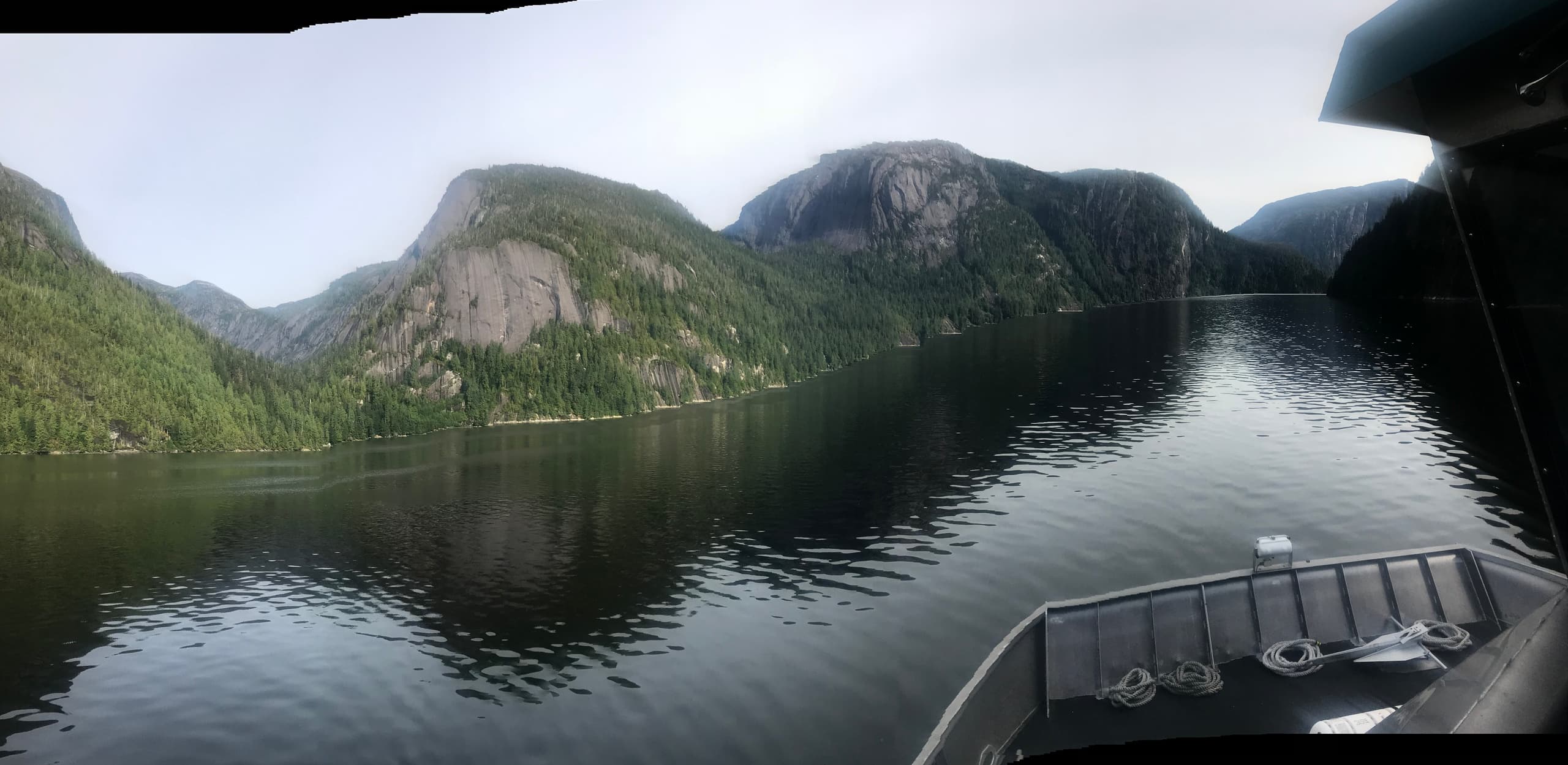 Scenic Alaska fjord from fishing boat, calm water panorama