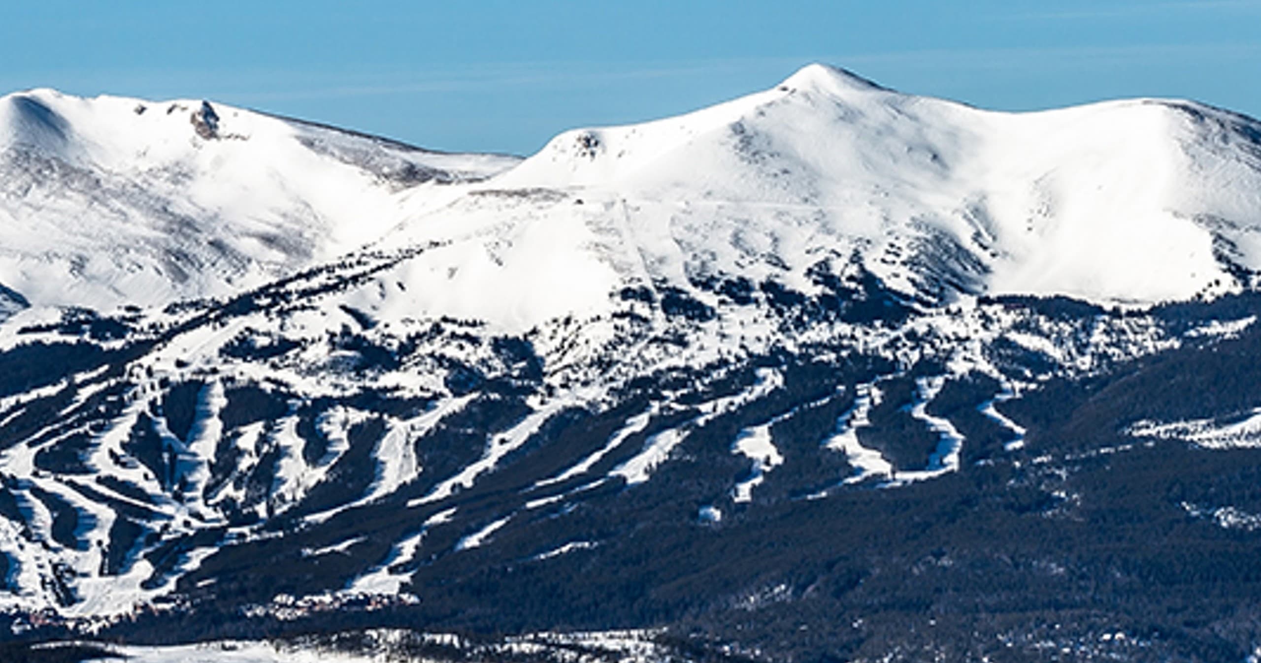 Panoramic snowy mountain with extensive ski runs and ridgelines