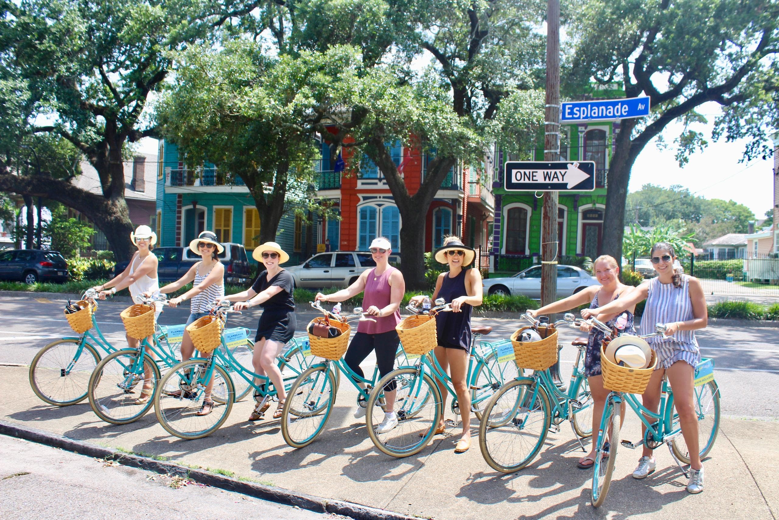Women lined up on pastel bicycles for guided city bike tour in New Orleans