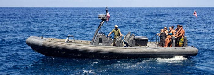 Adventure zodiac boat with guides and passengers on ocean tour