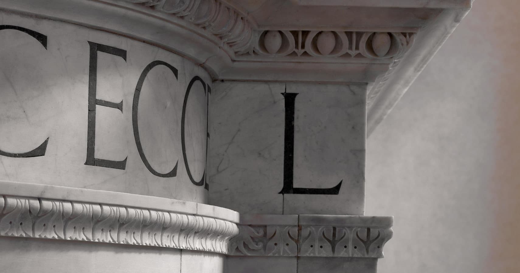 Marble inscription and architectural cornice detail inside museum