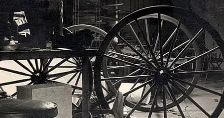 Close-up vintage carriage wheels in workshop, no outdoor view