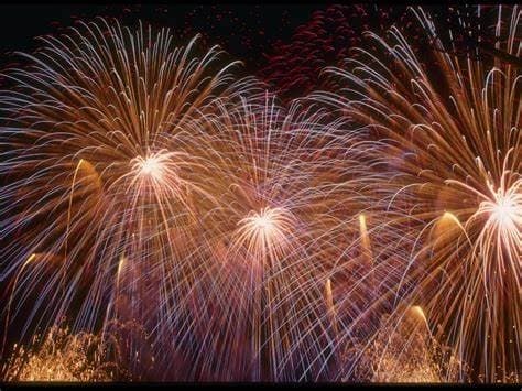 Night fireworks display over waterfront during holiday celebration
