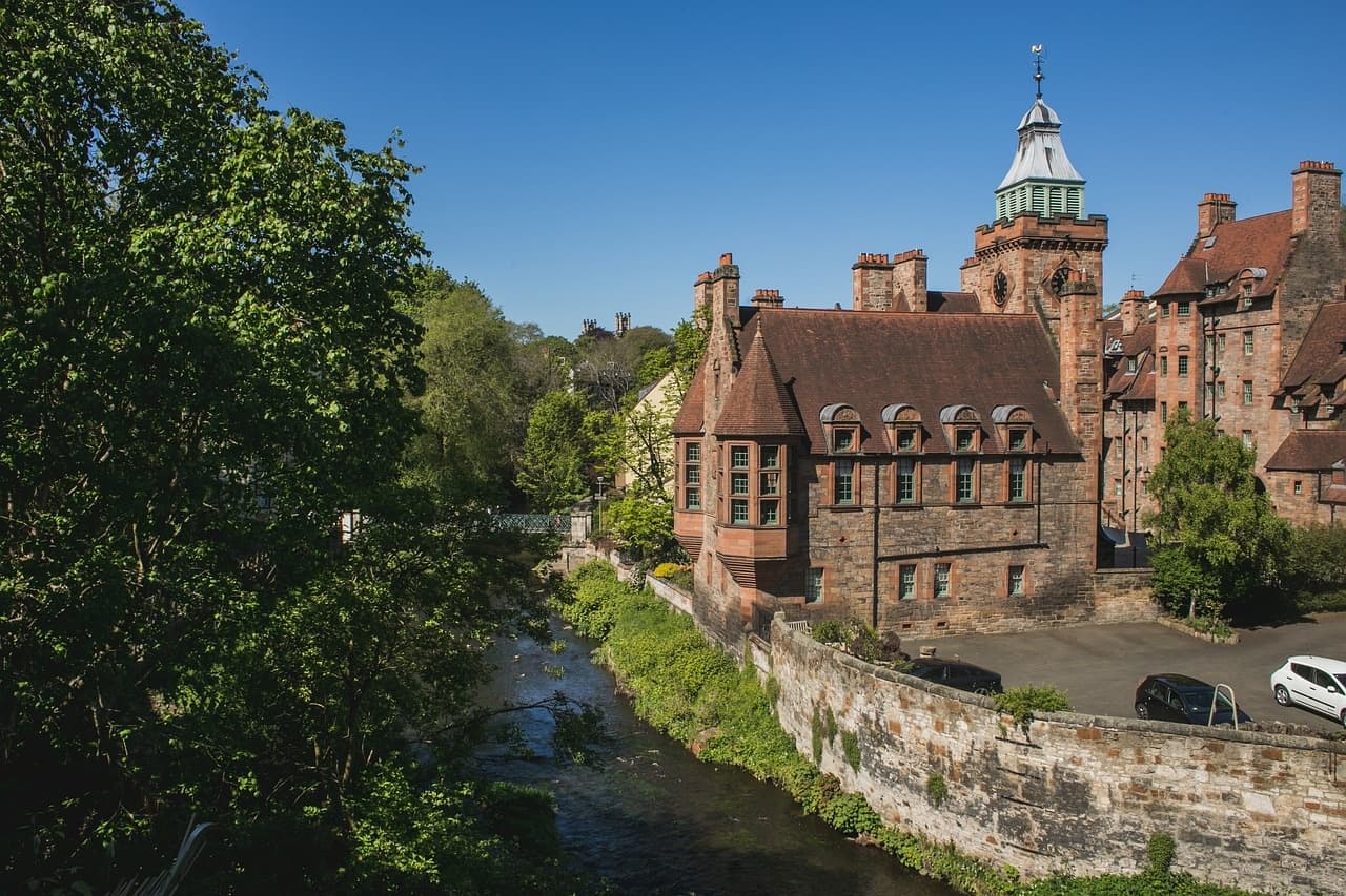 Riverside medieval castle and lush banks in scenic Scottish town