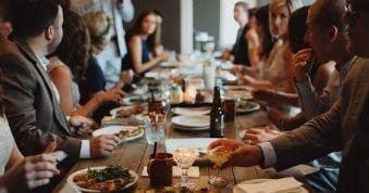 Group enjoying communal dining on Oxford food tour at restaurant