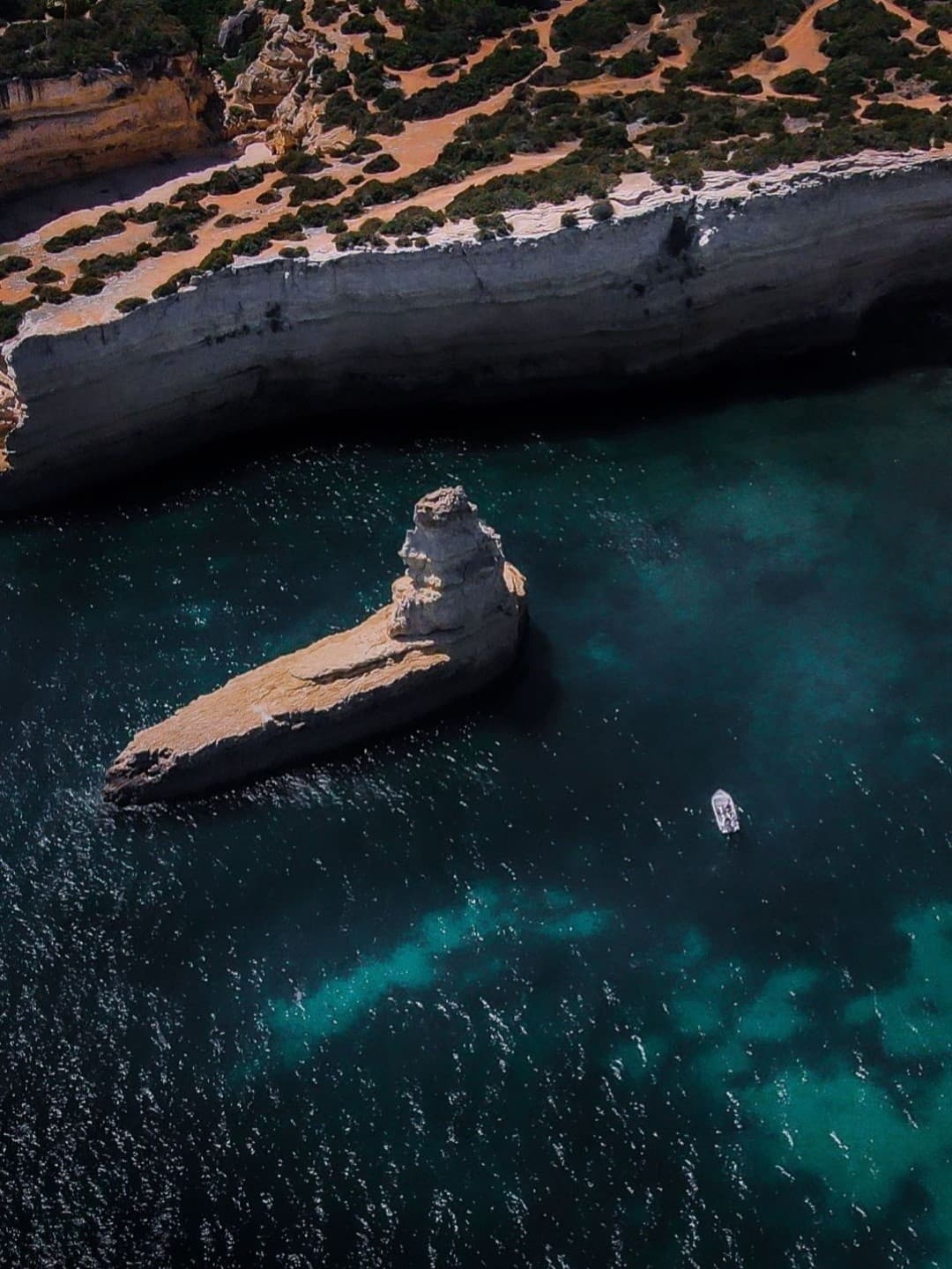 Aerial view of offshore limestone stack and turquoise water