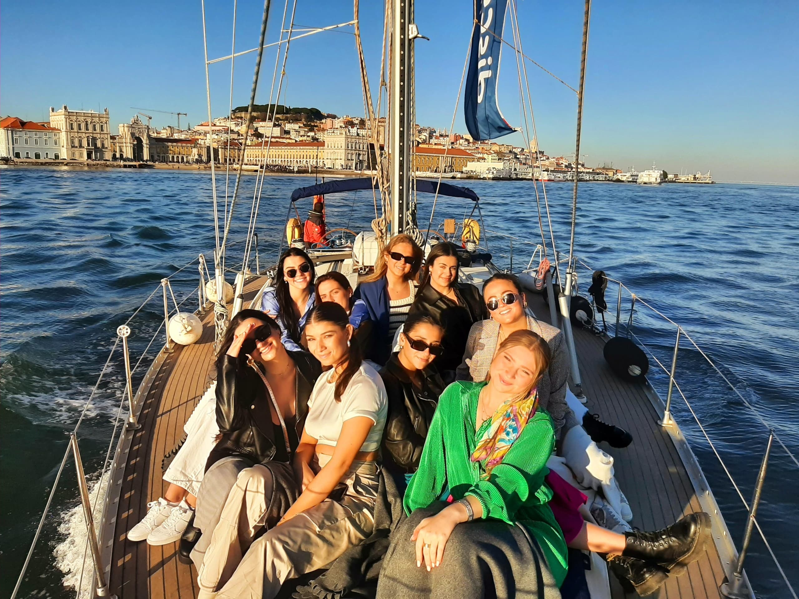 Group sailboat tour in Lisbon harbor enjoying day cruise