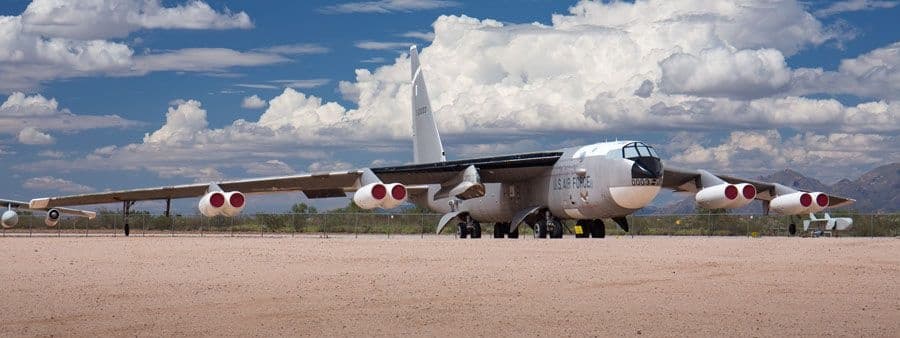 Vintage long-range bomber displayed on sunny airfield tarmac