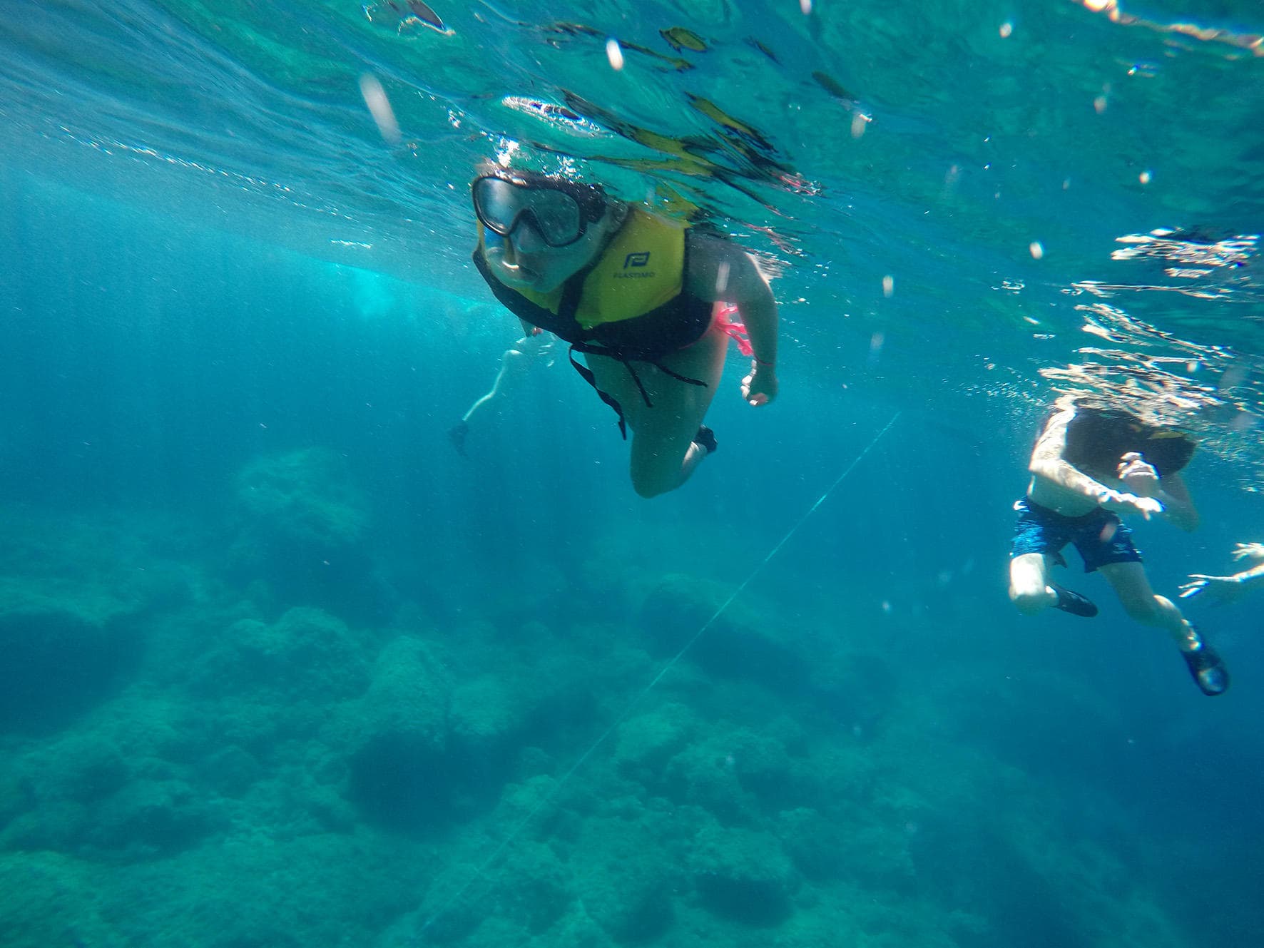 Snorkelers exploring clear underwater seascape near Mallorca shore