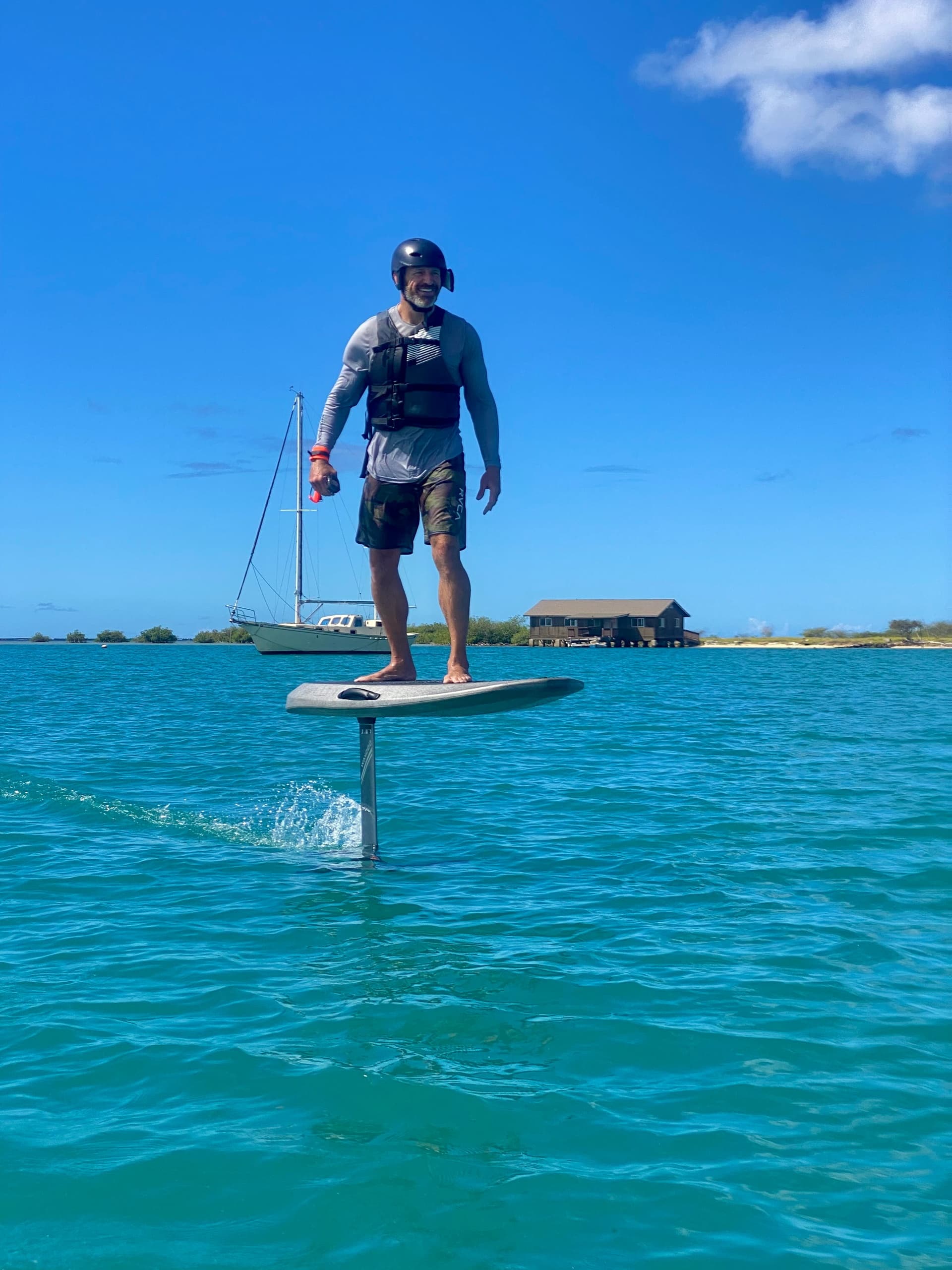 Electric hydrofoil surfing turquoise waters off Waikiki coast