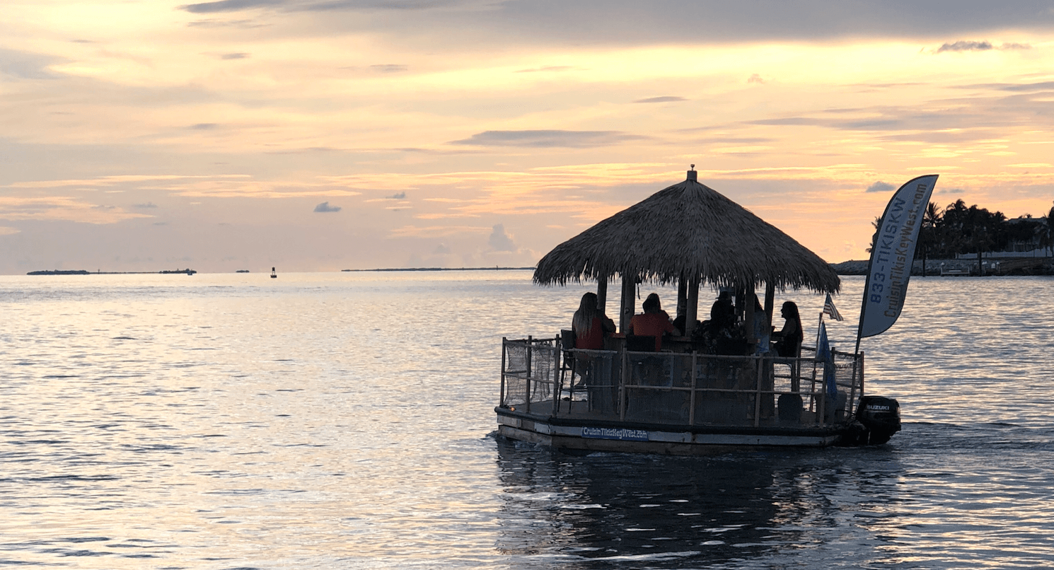 Sunset tiki boat cruise on calm ocean off Florida Keys