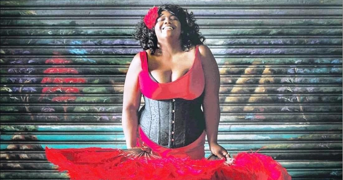 Jazz singer posing by urban metal shutter on city street
