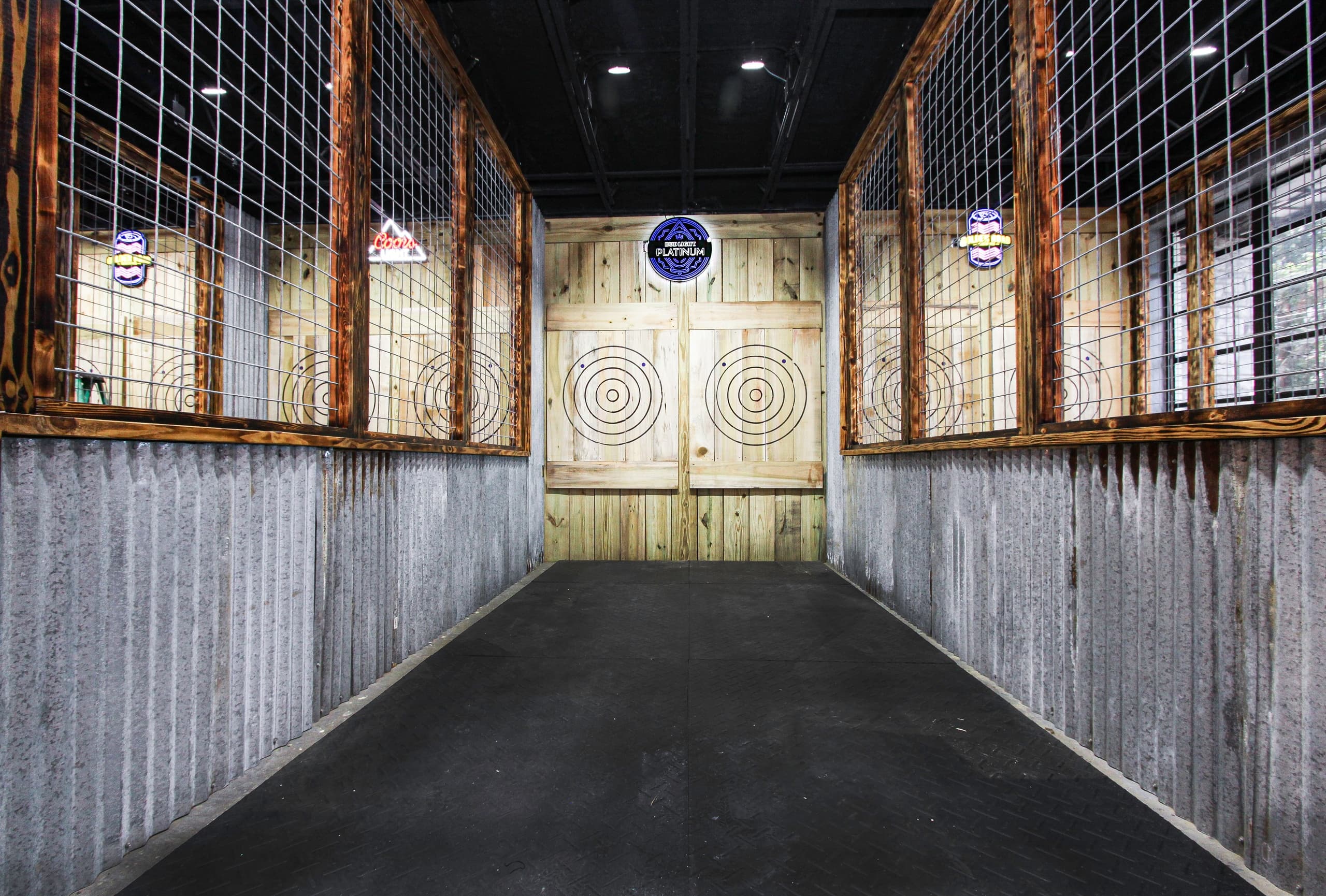 Axe throwing lane centered with wooden targets in indoor venue