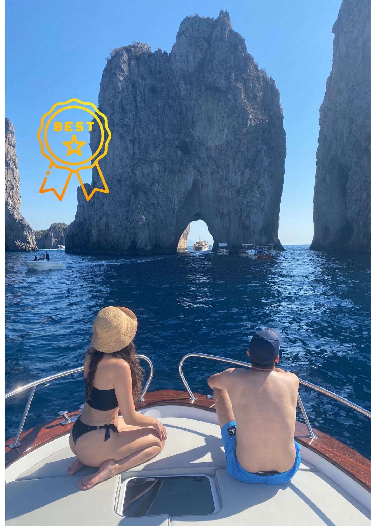 Couple seated on boat approaching Faraglioni rock arches, Capri