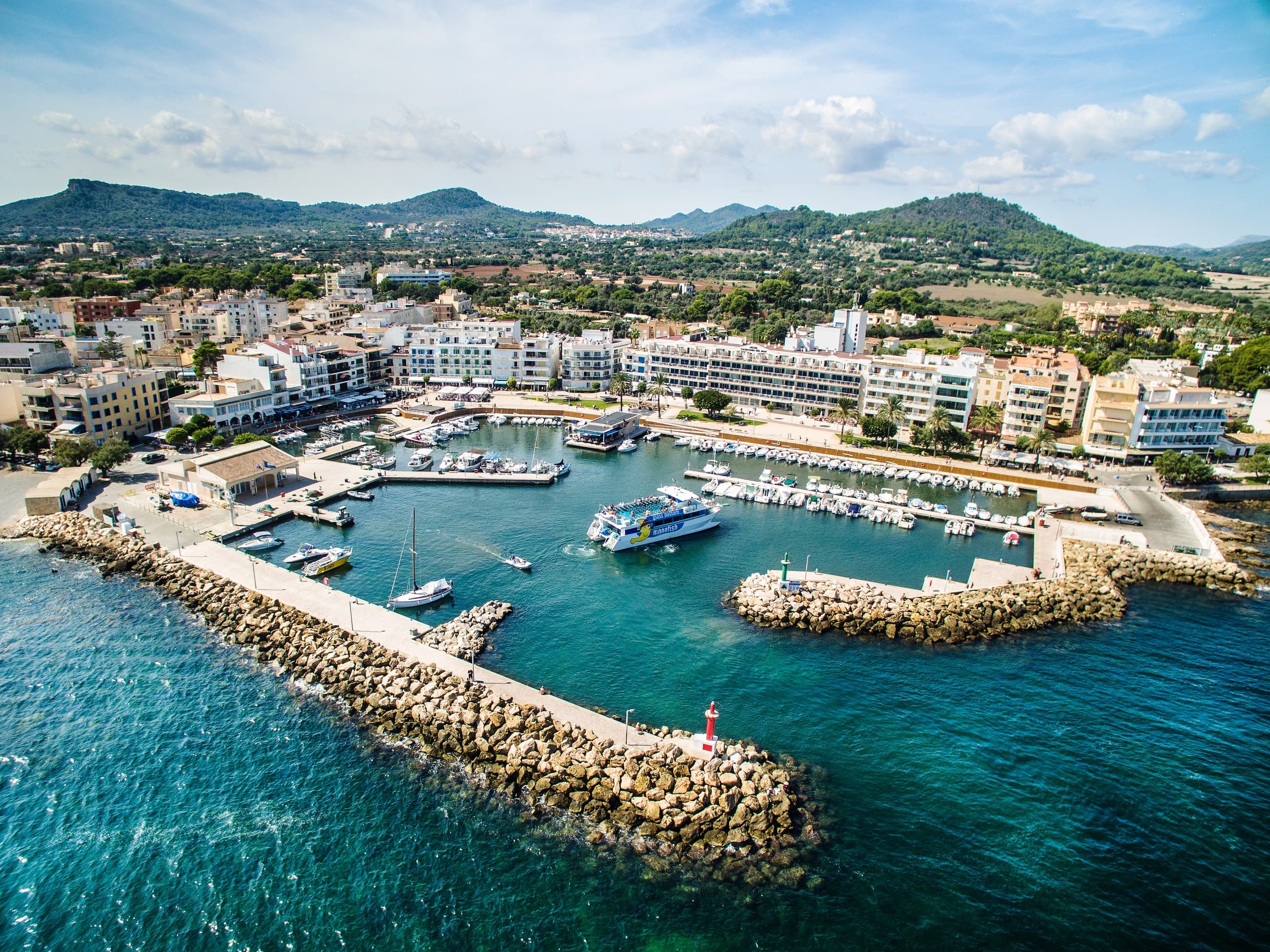 Aerial harbor panorama showing coastal marina and boat tours