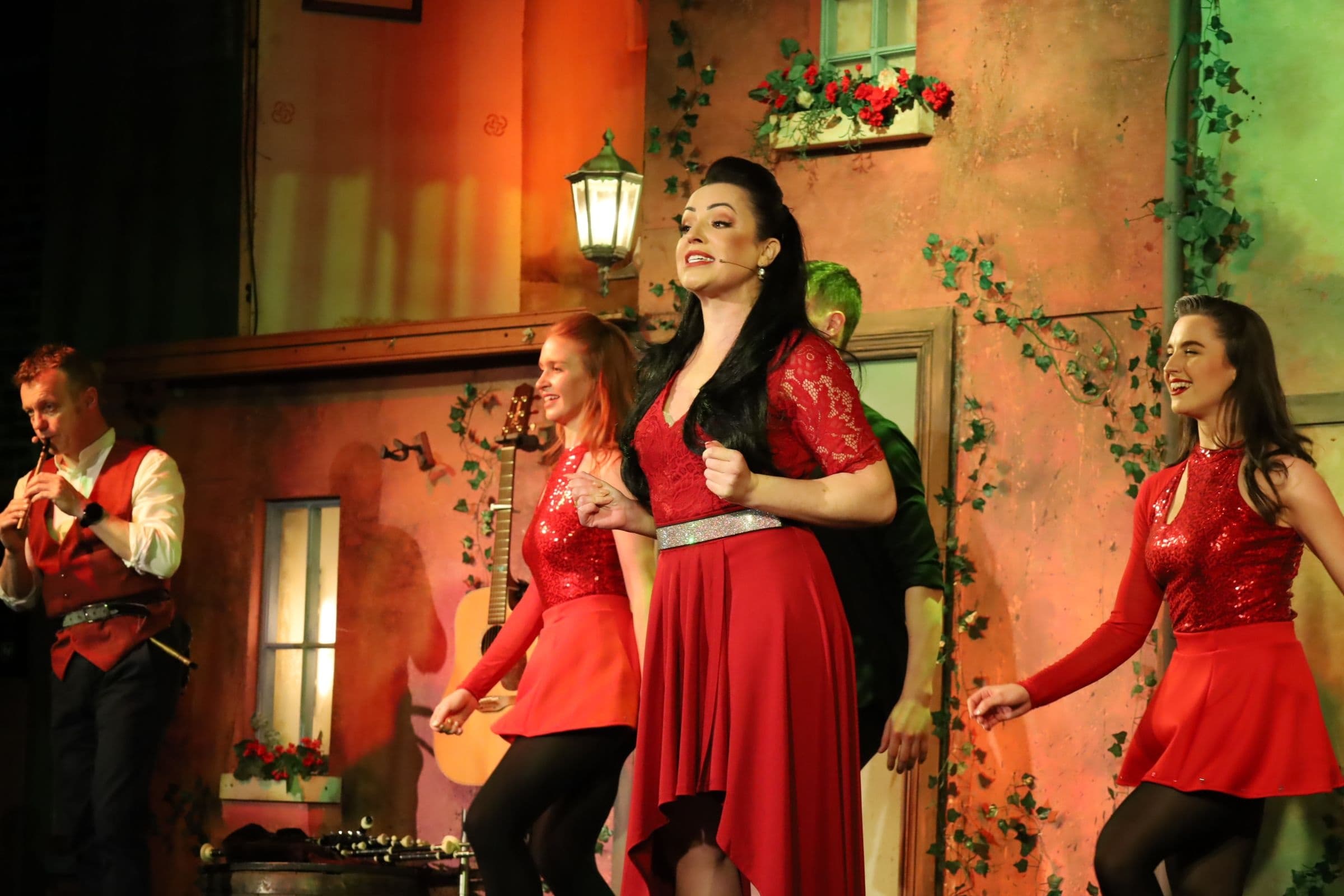 Female dancers performing Irish step show on indoor theater stage