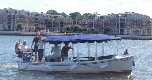 Group cruising on a covered tour boat in Baltimore harbor