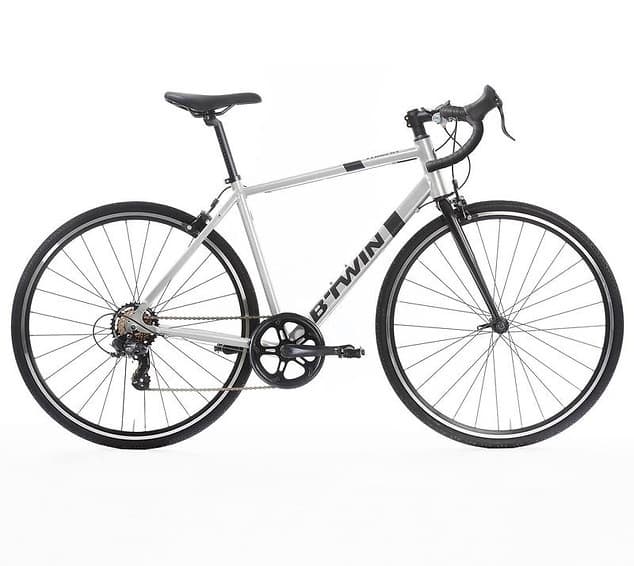 Silver road bike for long-distance cycling, studio white background