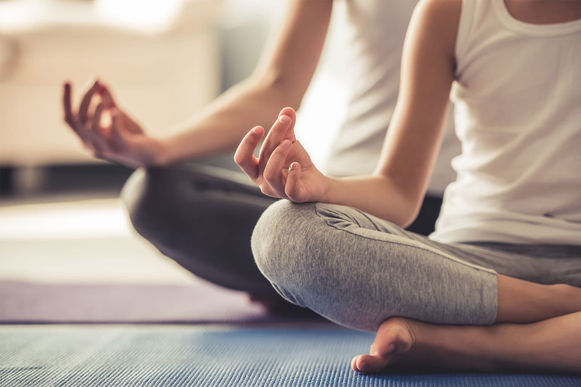 Couple practicing indoor yoga and meditation in resort studio