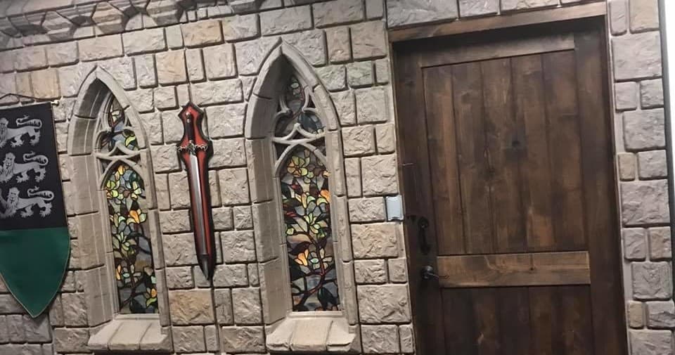 Medieval chapel-themed escape room wall with stained glass window