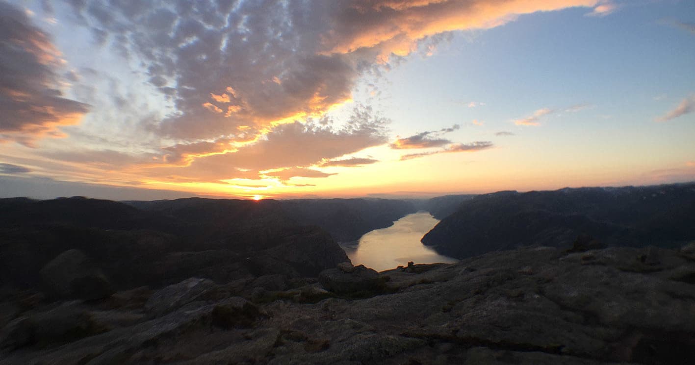 Sunset panorama over Lysefjord from high vantage showcasing hiking