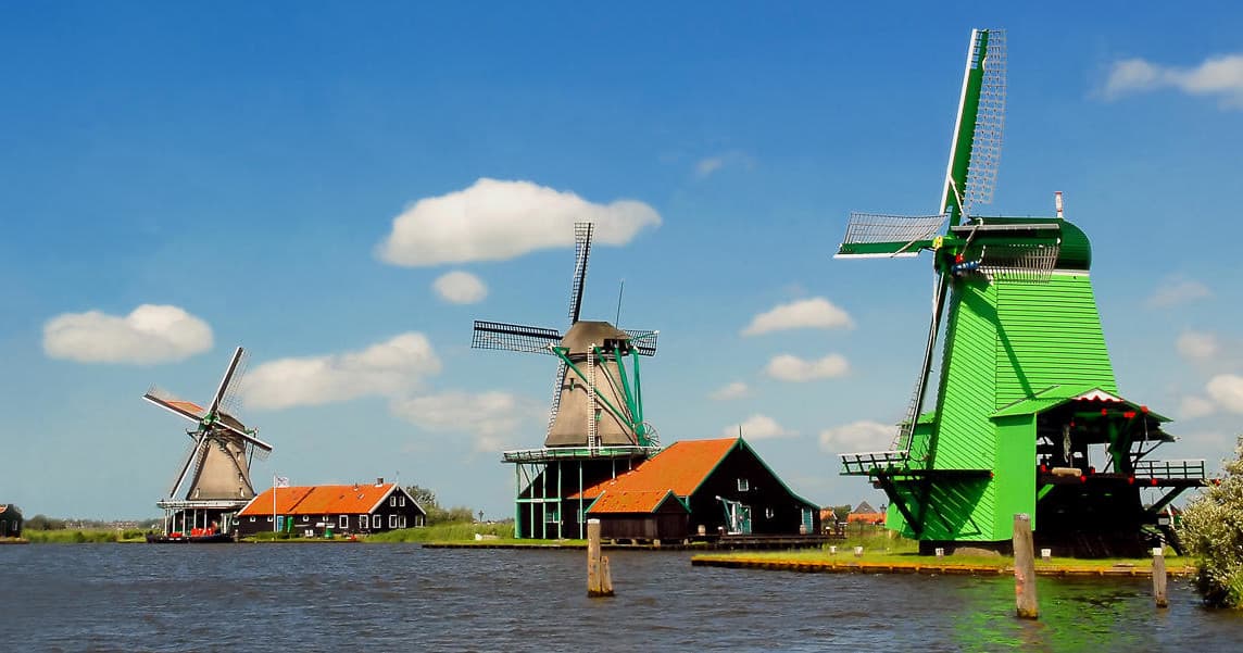 Classic Dutch windmills on water at open-air Zaanse Schans