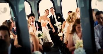 Wedding party riding vintage trolley through city streets and ceremony