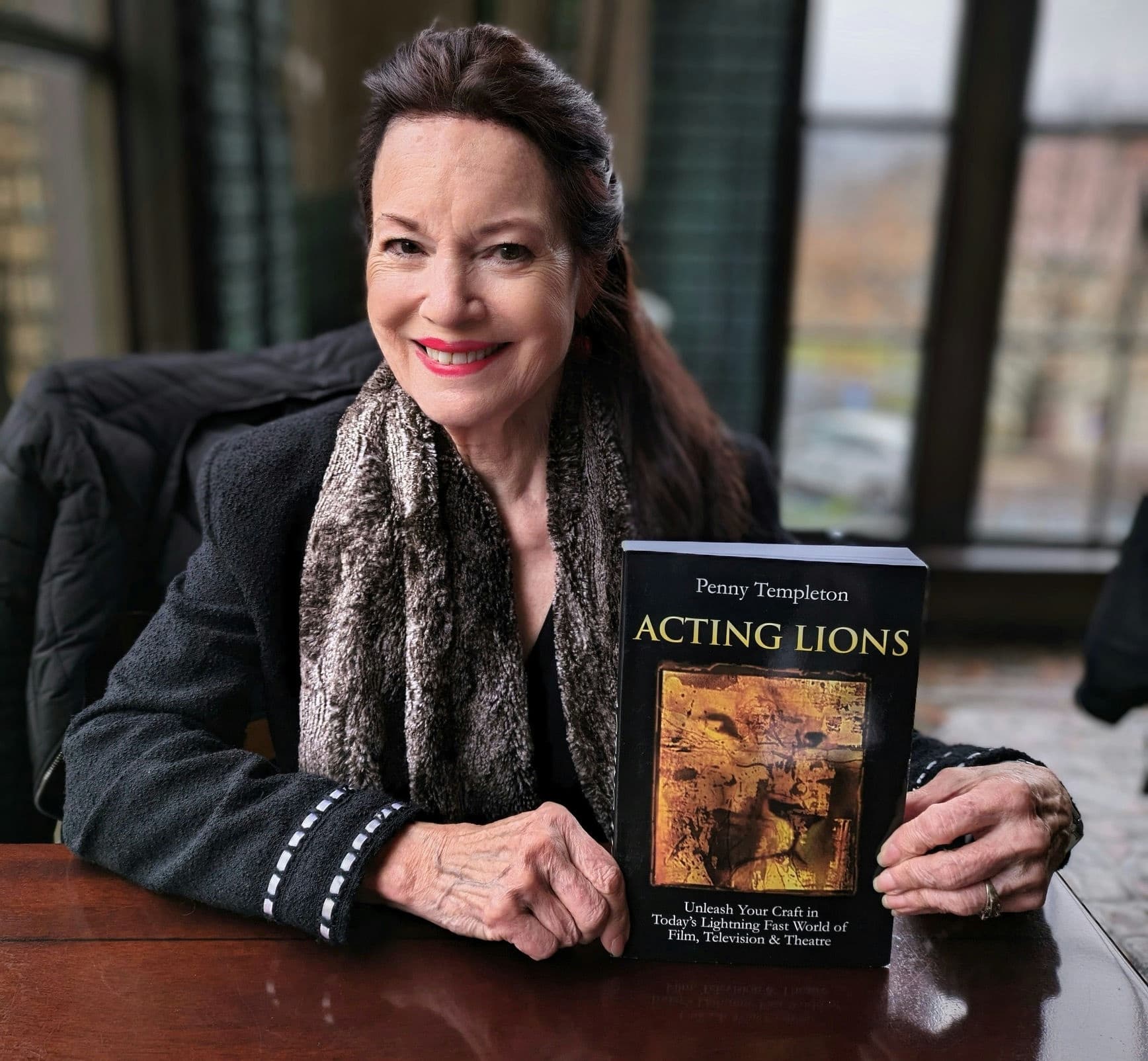 Acting coach holding book in studio interior portrait