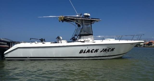 White center-console boat cruising clear Key Largo waters