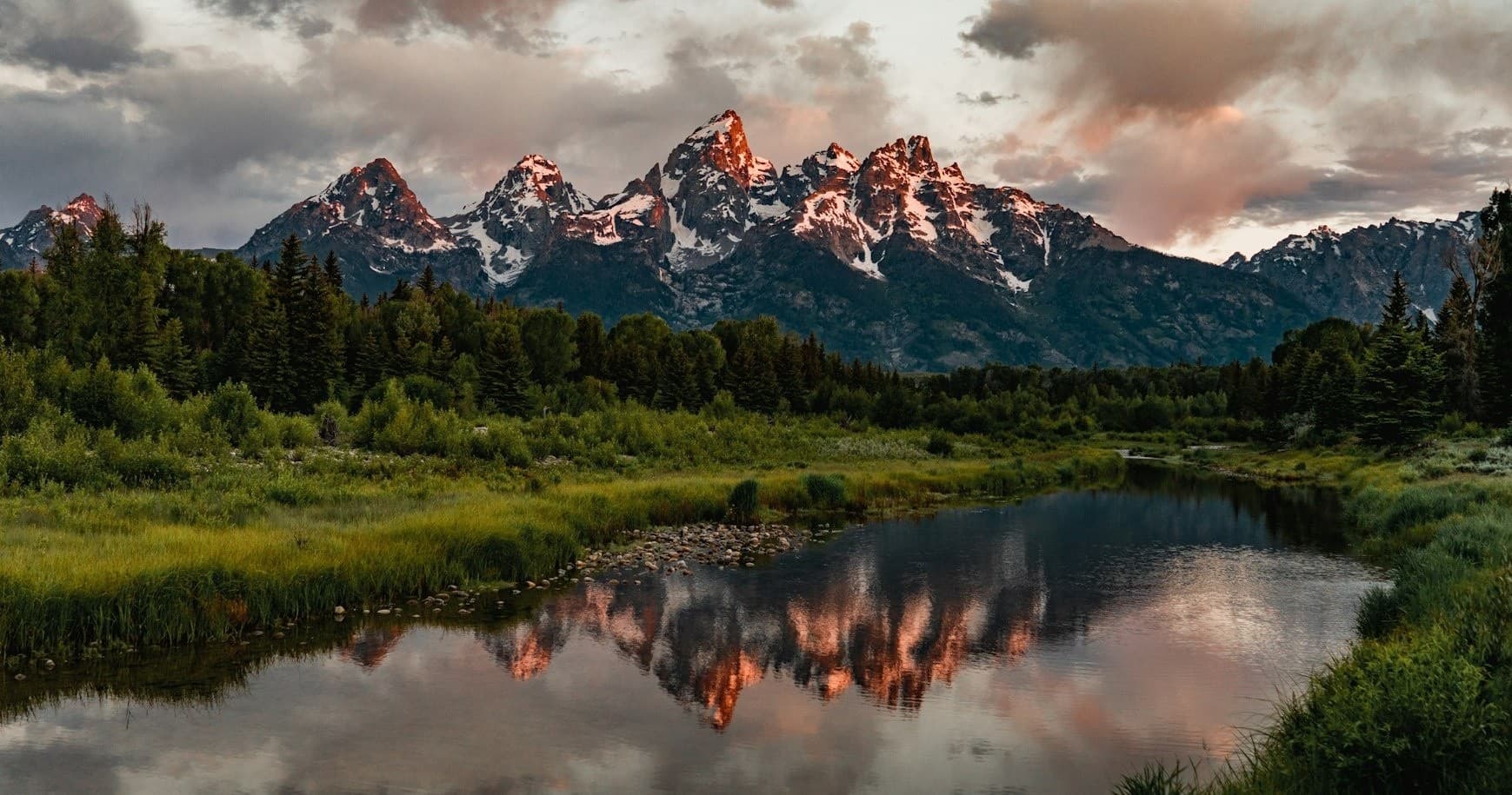 Sunset mountains reflected in alpine lake Grand Teton view