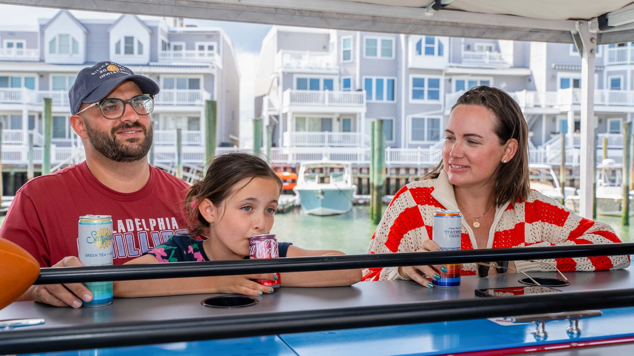 Family enjoying drinks at covered bar on a harbor boat, Jersey Shore