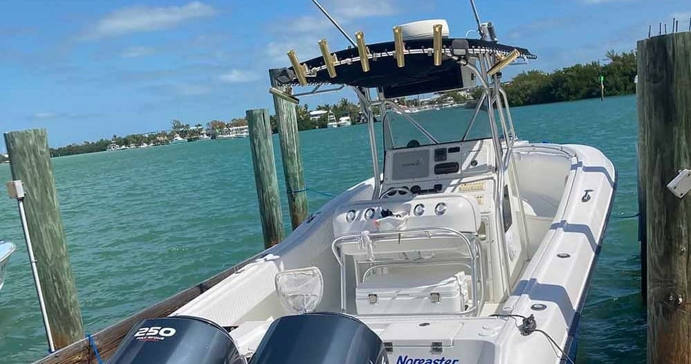 Center console sportfishing boat docked in turquoise coastal waters