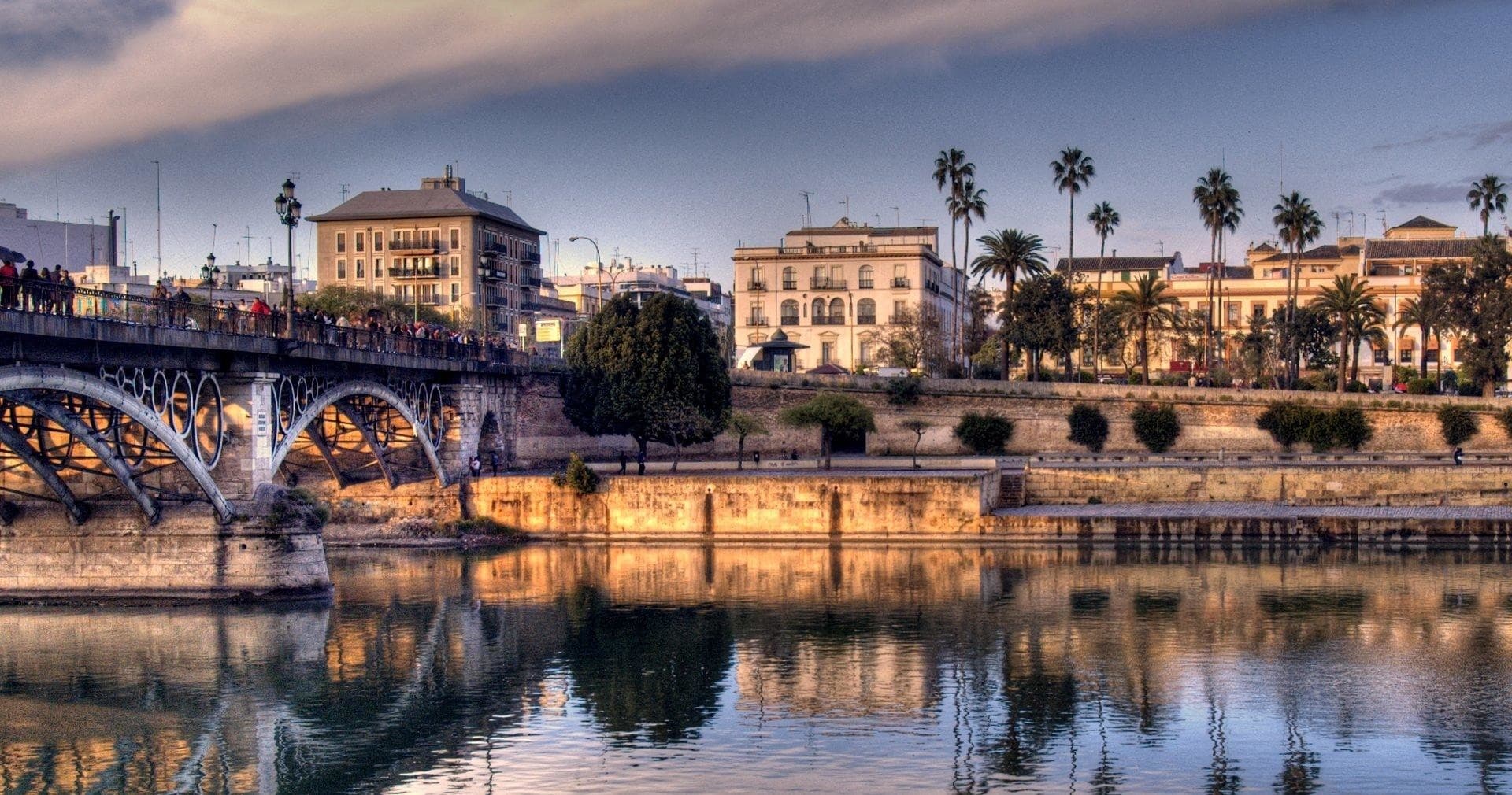 Guadalquivir River and Triana bridge reflecting Seville sunset