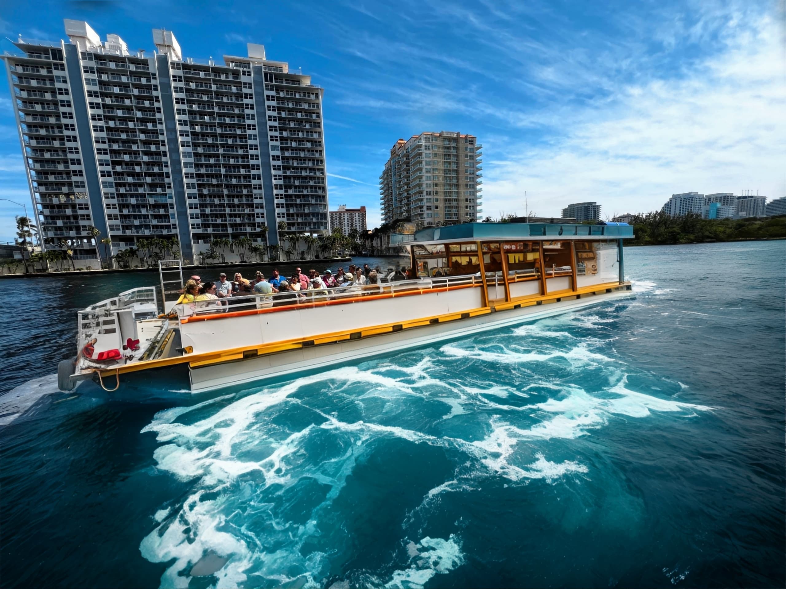 Water taxi cruising past Miami high-rises with ocean wake
