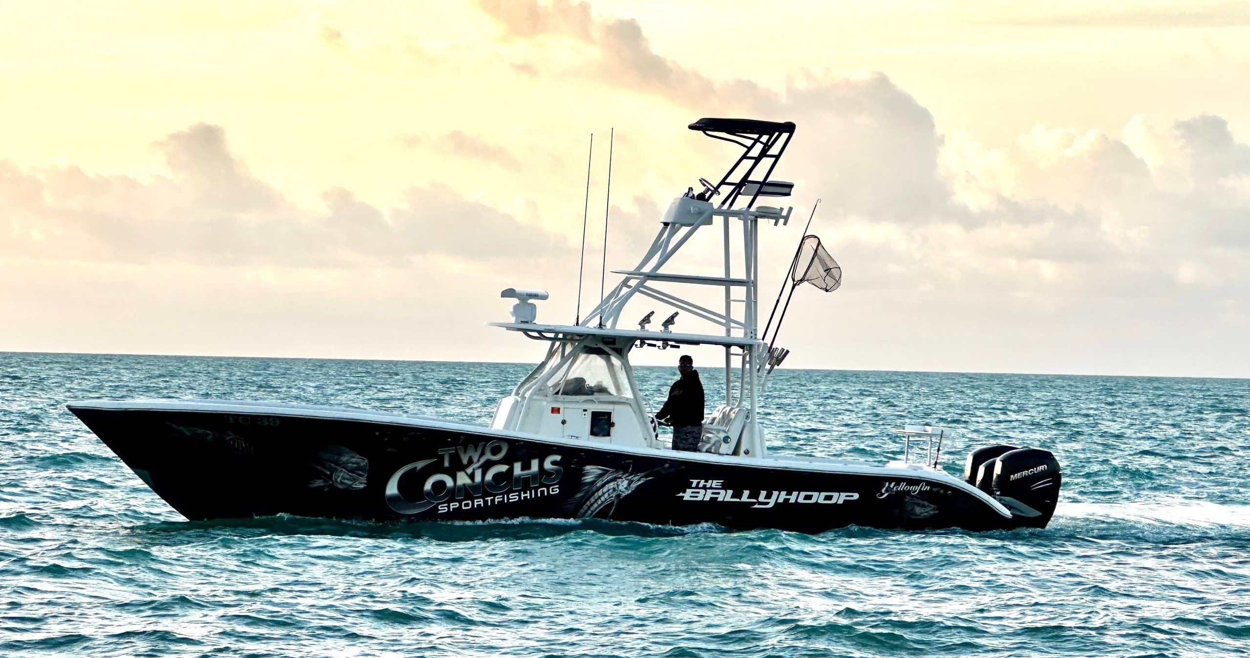 Sportfishing charter boat cruising offshore Miami waters at sunrise