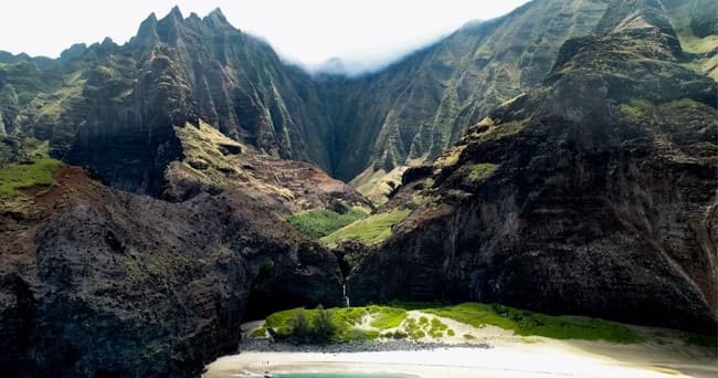 Dramatic Napali Coast sea cliffs with secluded beach, Kauai