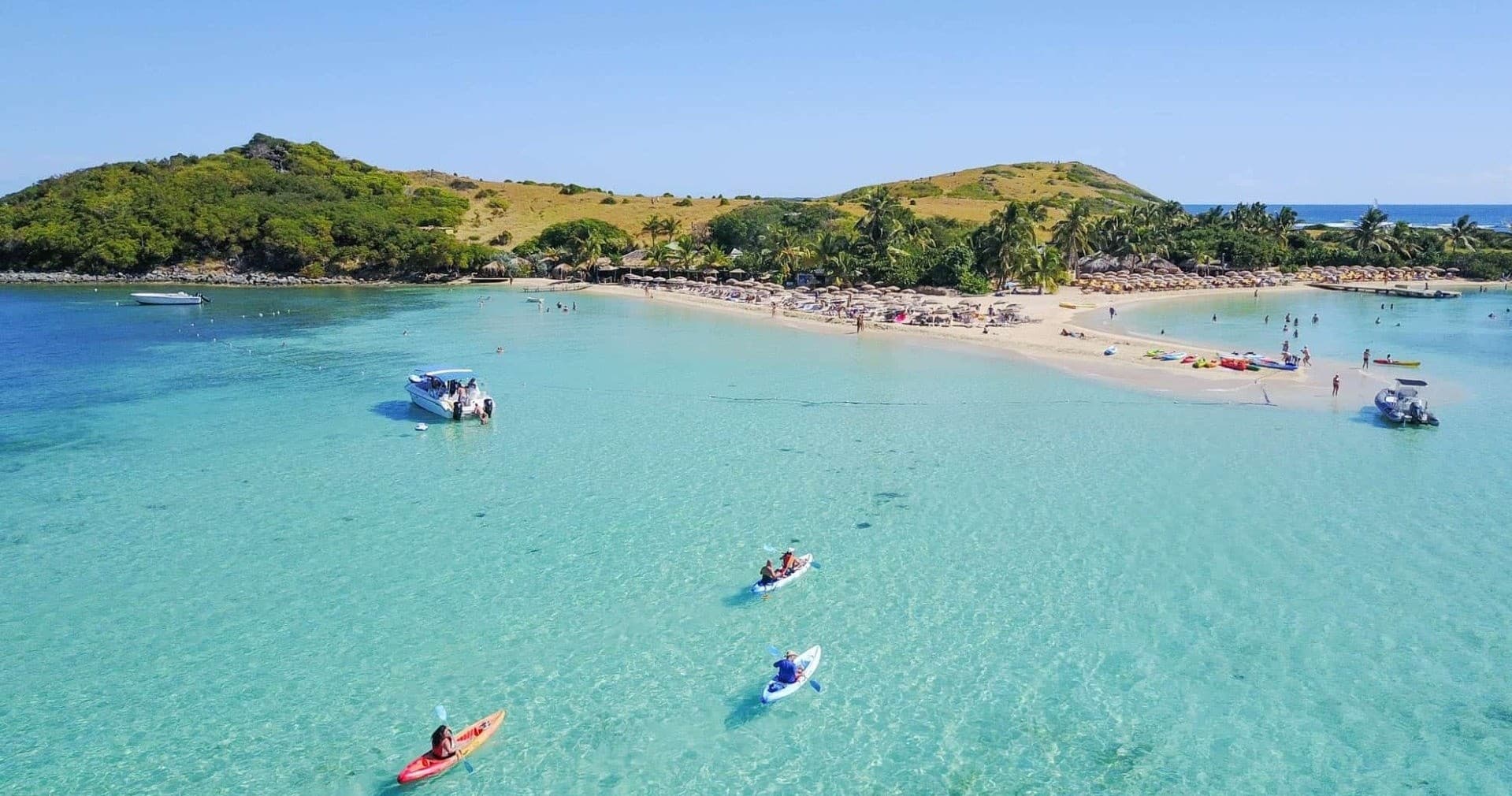 Aerial view of kayakers in turquoise Caribbean bay near coast