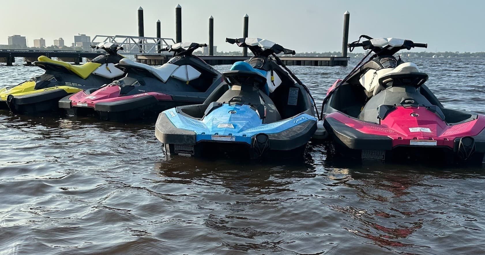 Jet skis docked on a lake ready for guided riding and water adventures